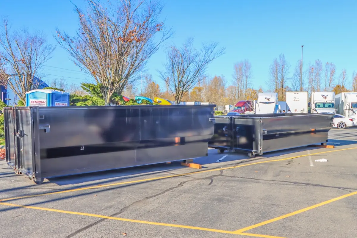 Professional dumpster rental service with roll-off container on residential driveway in Sun Prairie
